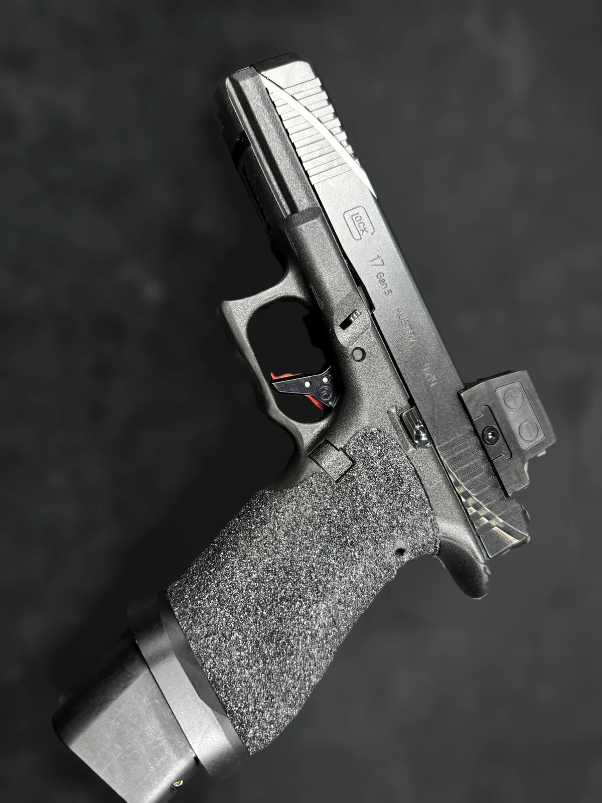 Custom Glock 17 Gen 5 build with stippled grip, optic and red trigger